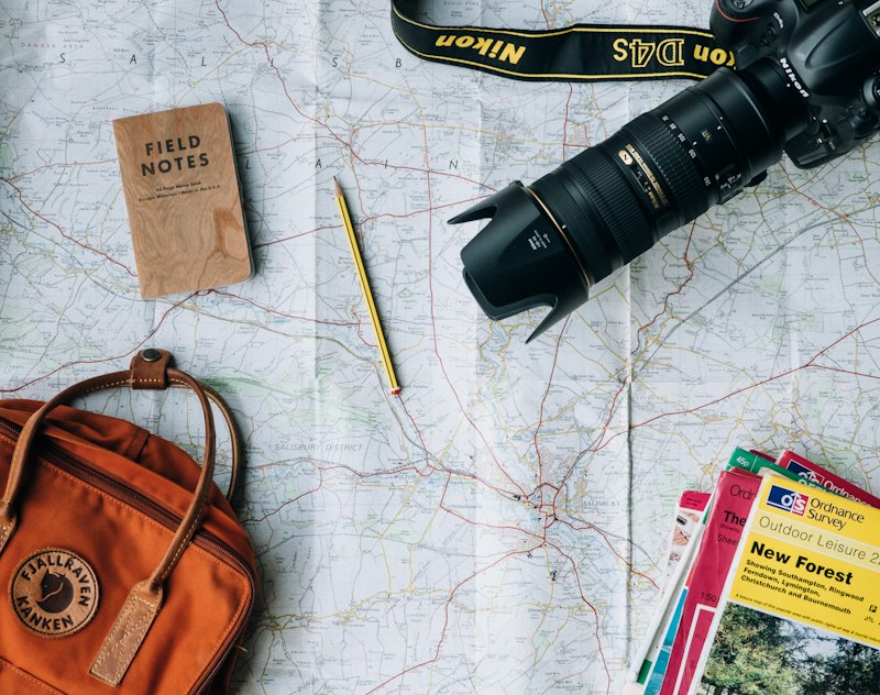 Traveler with camera and map planning a trip